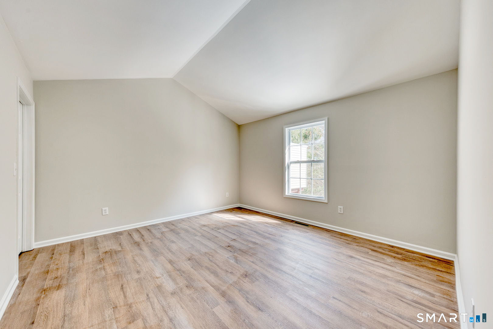 159 Jennifer Lane, Unit 159 Newtown, CT 06482 - Photo 20 of 32 an empty room with wooden floor and windows
