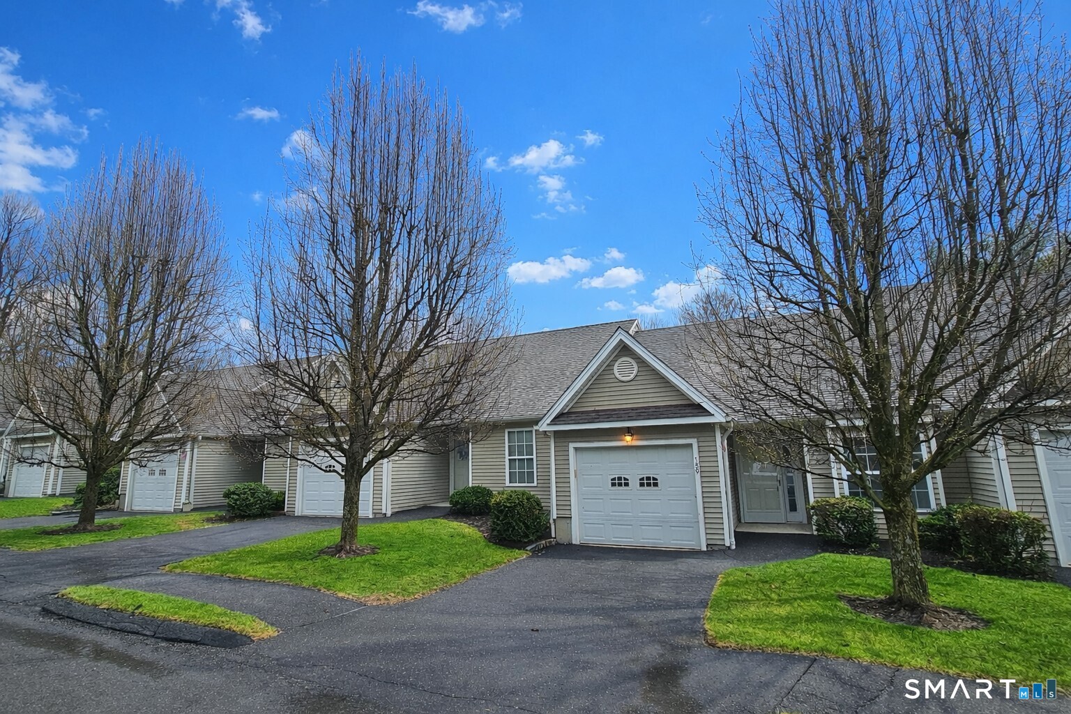 159 Jennifer Lane, Unit 159 Newtown, CT 06482 - Photo 2 of 32 a view of a white house with a yard and large tree
