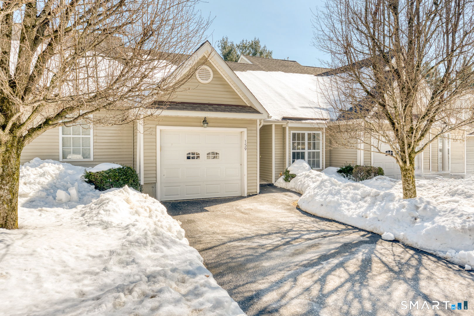 159 Jennifer Lane, Unit 159 Newtown, CT 06482 - Photo 3 of 29 a front view of a house with a yard covered in snow