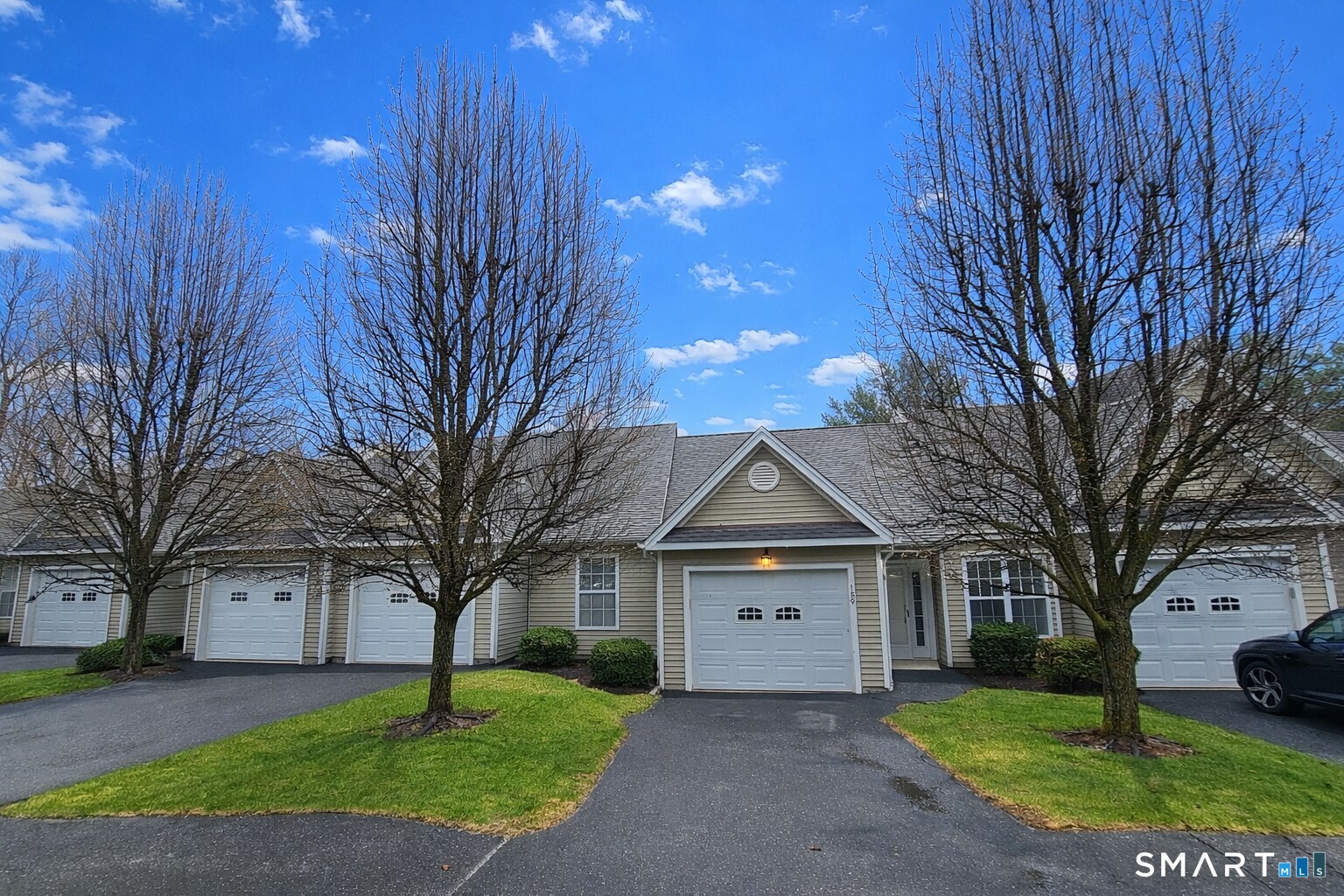 159 Jennifer Lane, Unit 159 Newtown, CT 06482 - Photo 4 of 32 a front view of a house with a yard and tree