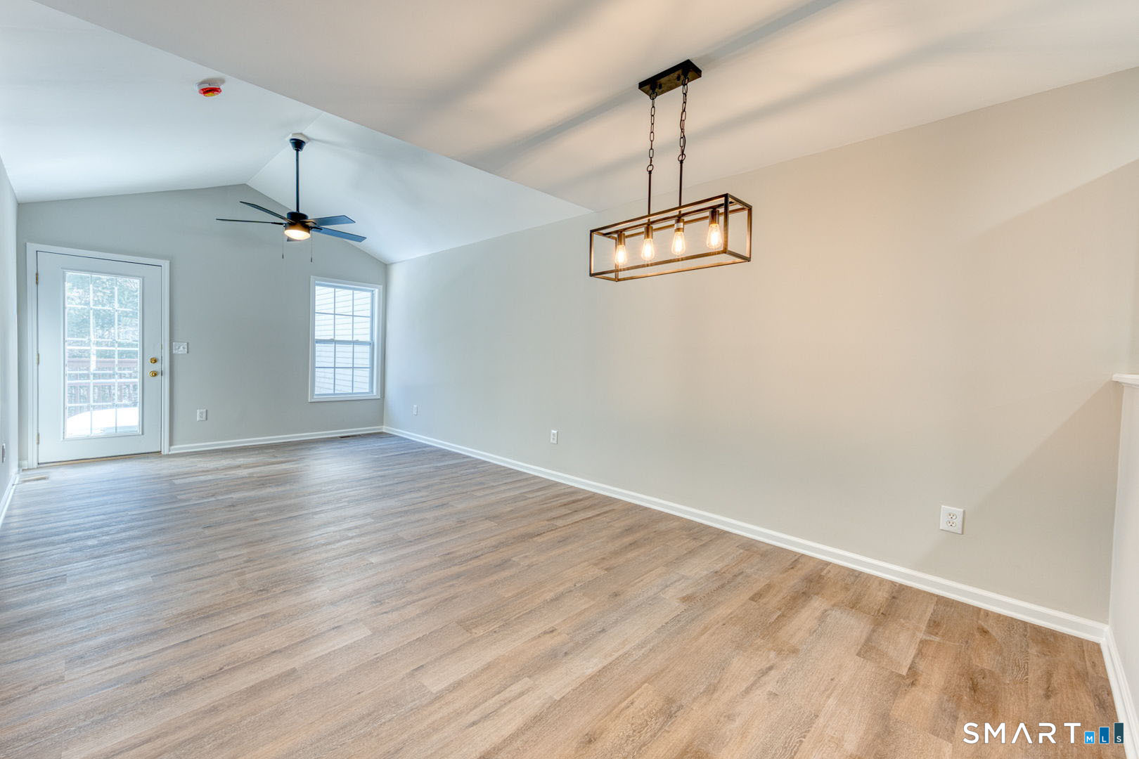 159 Jennifer Lane, Unit 159 Newtown, CT 06482 - Photo 9 of 32 a view of an empty room with window and wooden floor