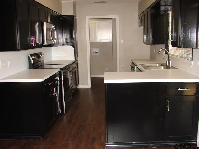 a en suite bathroom with a sink double vanity granite and a mirror