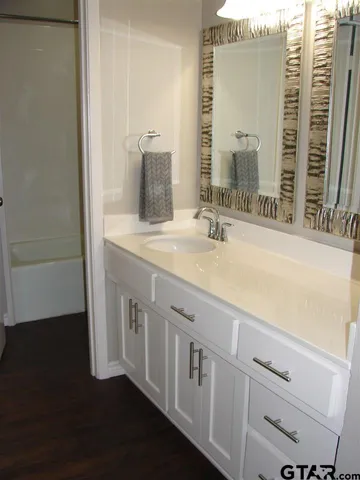 a bathroom with a double vanity sink and a mirror