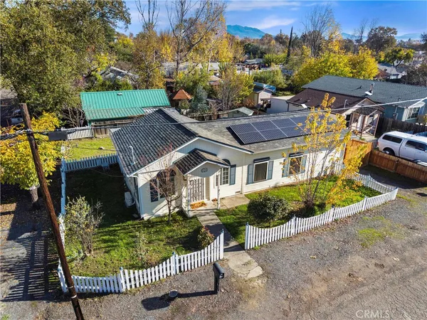 an aerial view of a houses with a swimming pool