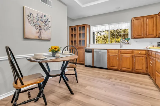 a dining room with a wooden table and chairs