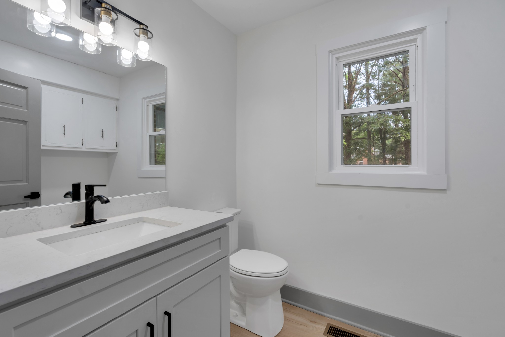 305 12 Oaks Road Tullahoma, TN 37388 - Photo 18 of 56 a bathroom with a sink a toilet and a window