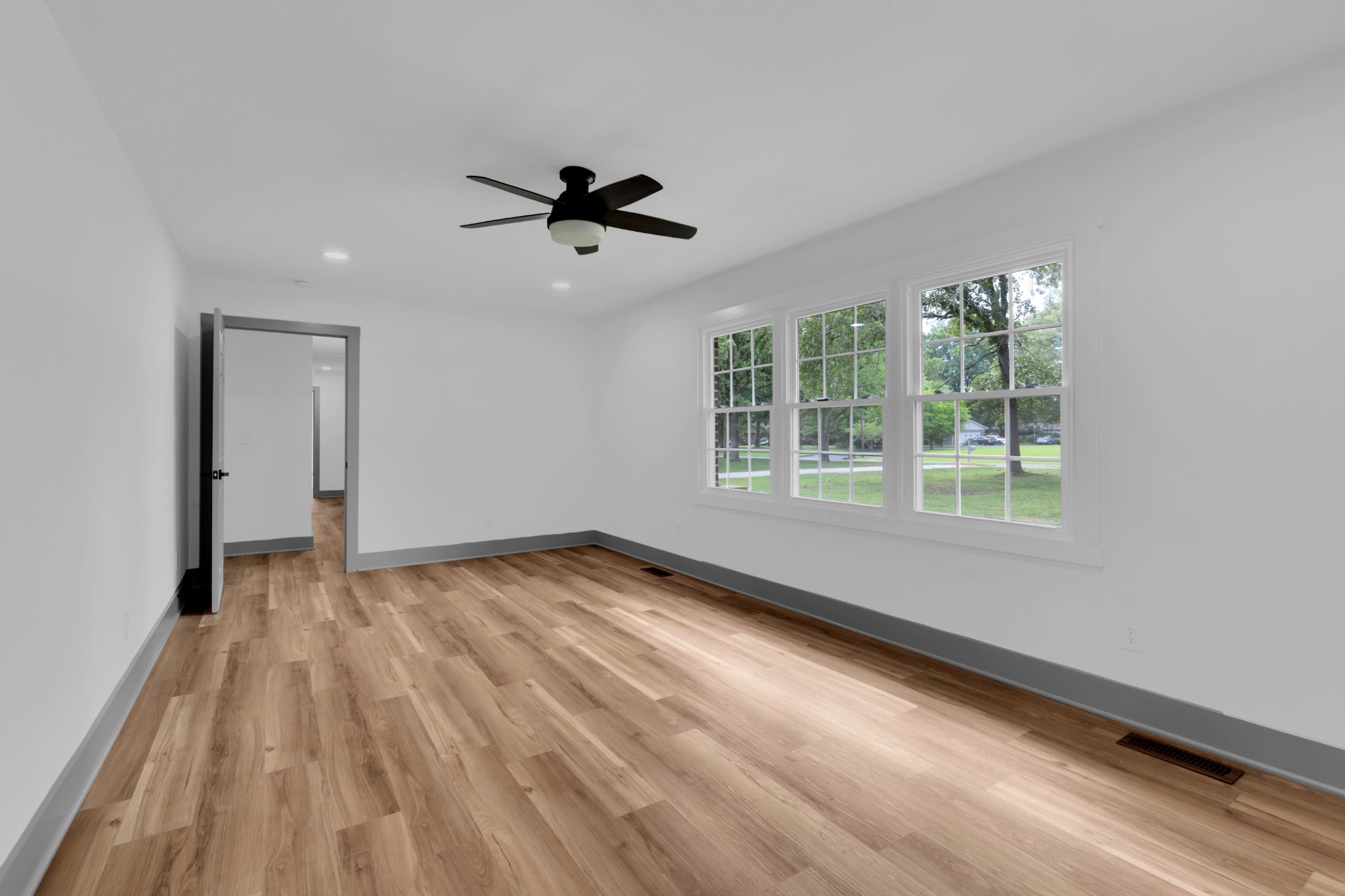 305 12 Oaks Road Tullahoma, TN 37388 - Photo 20 of 56 a view of empty room with wooden floor and fan