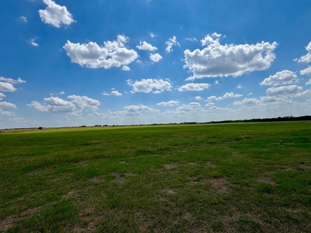 323 Slaughter Road Olney, TX 76374 - Photo 15 of 18 a view of a big yard with lots of yellow lighting