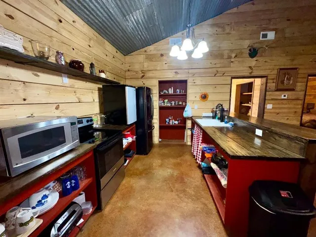 a kitchen with stainless steel appliances granite countertop a stove and a microwave