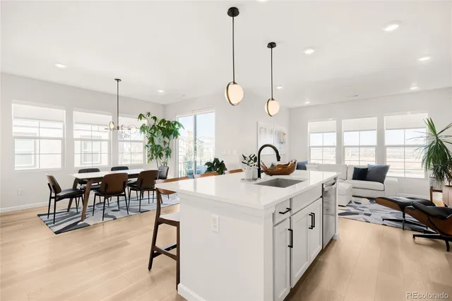 a kitchen with sink a table and chairs in it