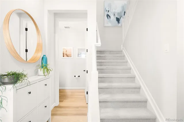a view of a hallway with wooden floor and entryway