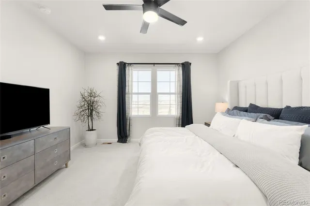 a bedroom with a bed and a flat screen tv on dresser