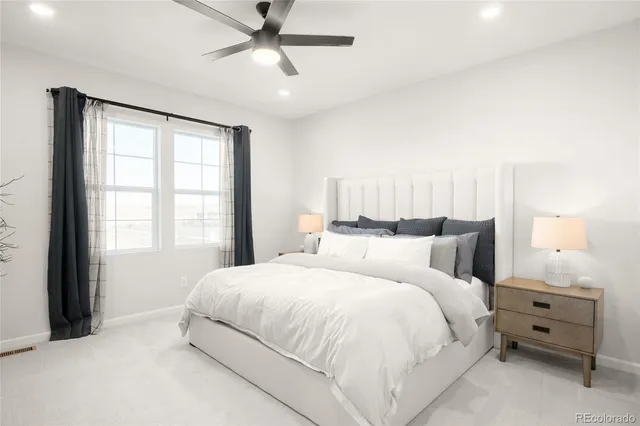 a large bed sitting in a bedroom next to a window