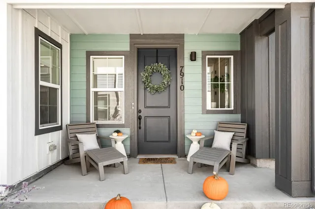 a living room with furniture and two windows