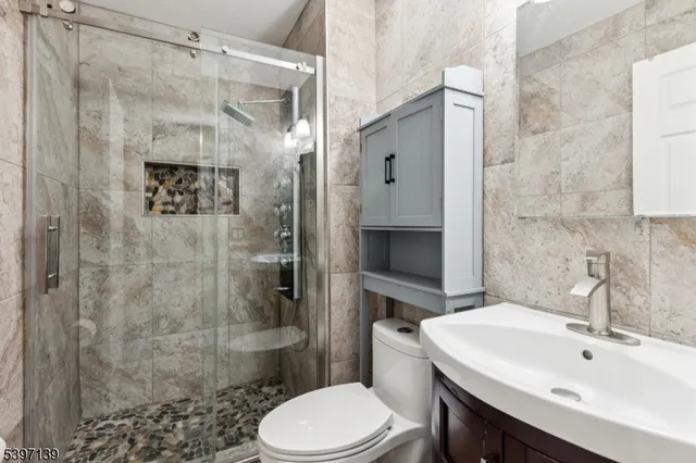 a bathroom with a sink toilet and shower