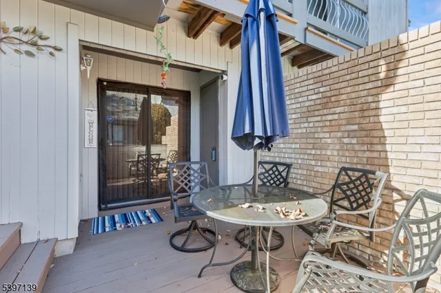 a view of a backyard with table and chairs
