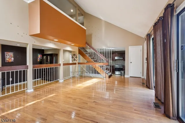 a view of a hall with stairs and a windows