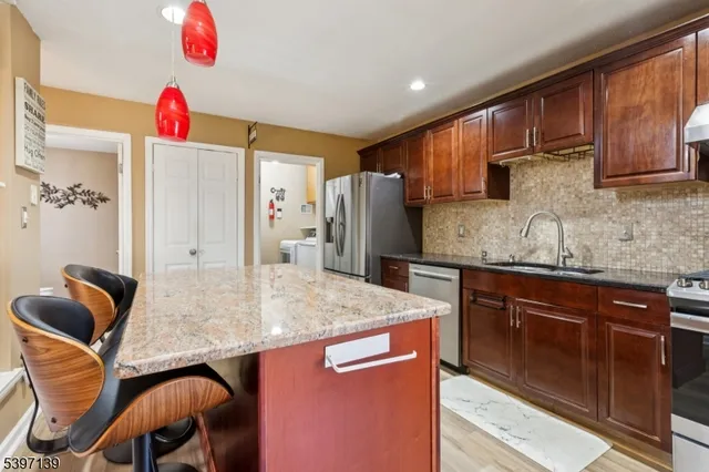 a kitchen with cabinets and wooden floor
