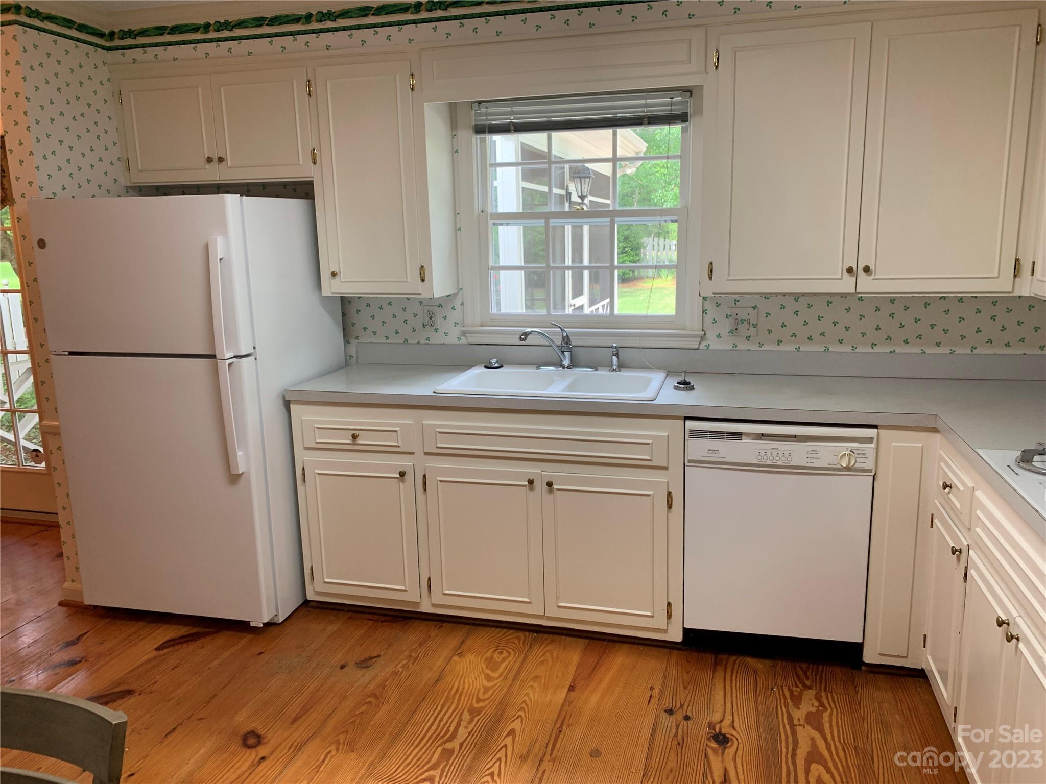 909 Nightingale Road Rock Hill, SC 29732 - Photo 11 of 38 a kitchen with white cabinets white appliances and sink