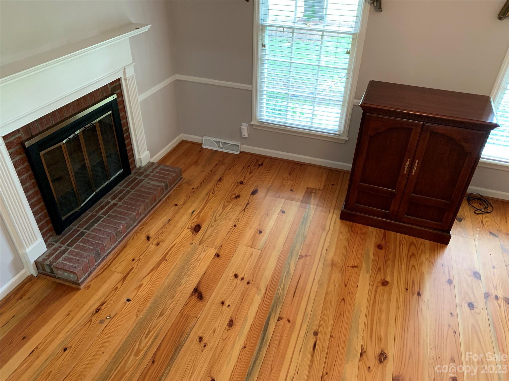 909 Nightingale Road Rock Hill, SC 29732 - Photo 12 of 38 a view of an empty room with wooden floor and a window