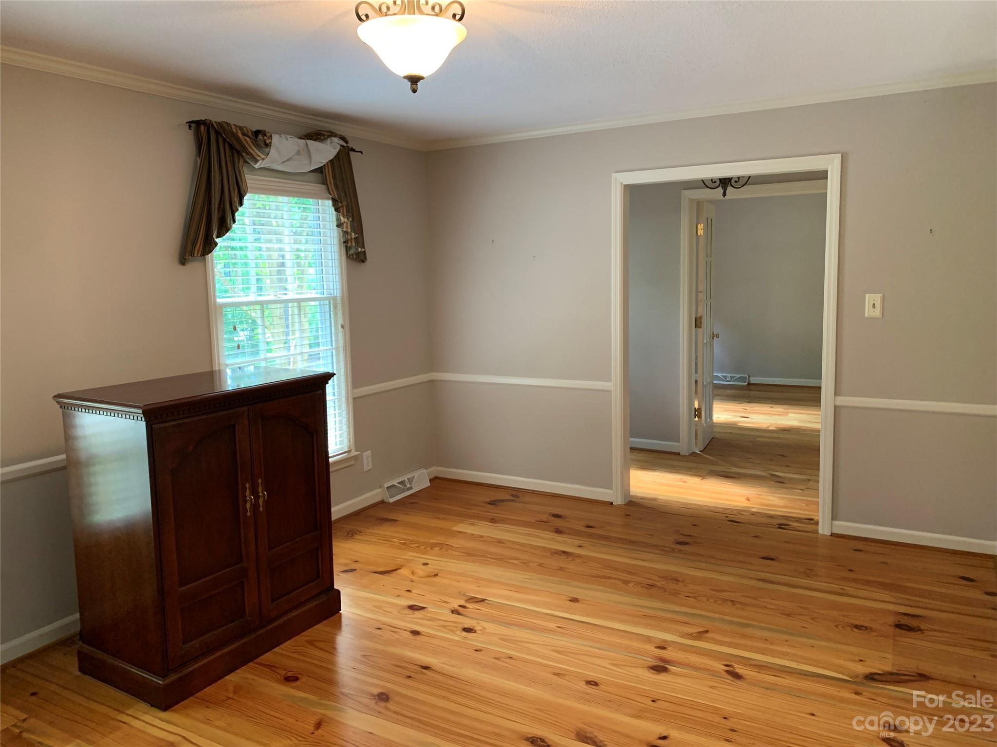 909 Nightingale Road Rock Hill, SC 29732 - Photo 2 of 38 an empty room with wooden floor cabinet and windows