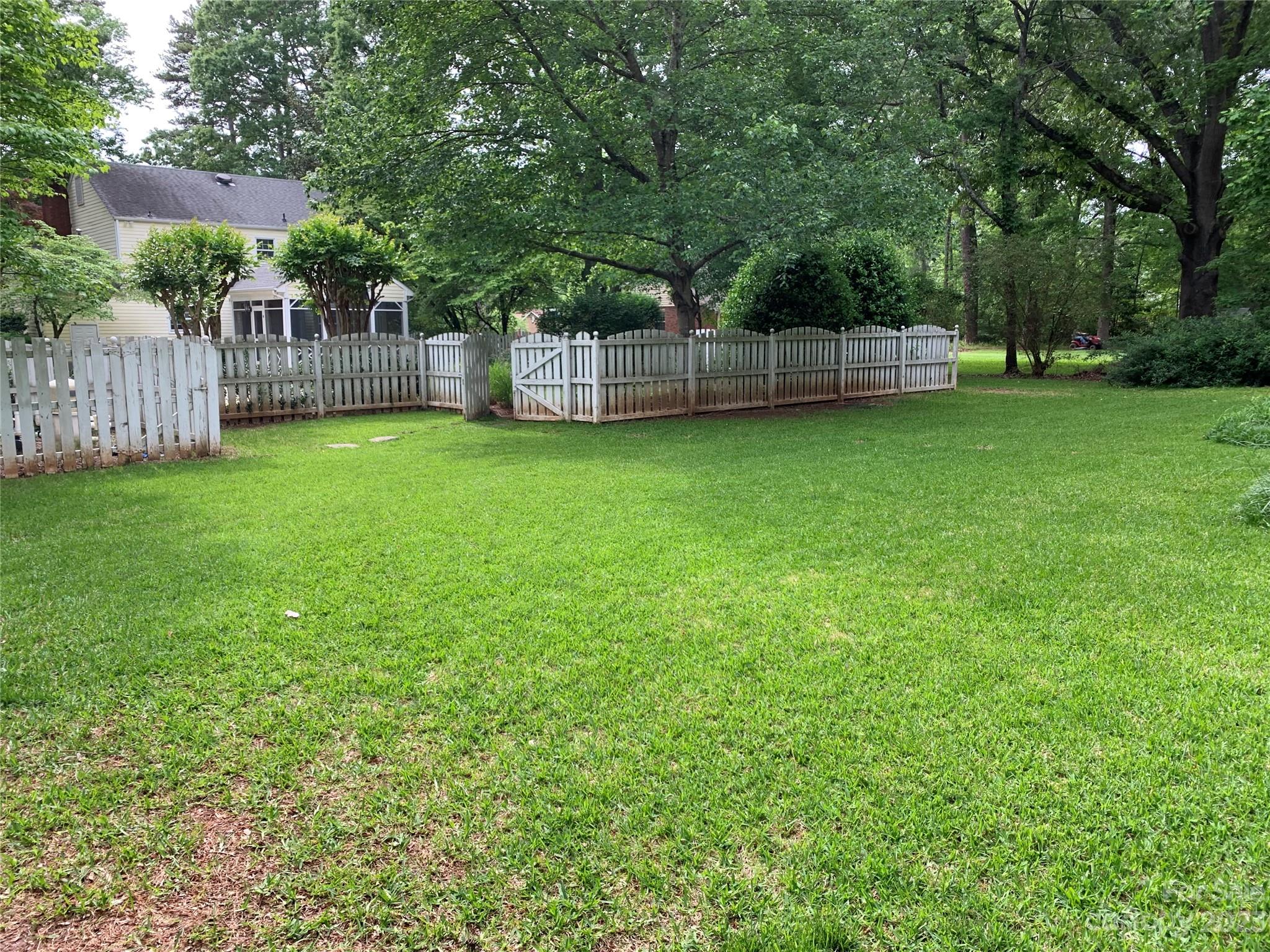 909 Nightingale Road Rock Hill, SC 29732 - Photo 33 of 38 a view of a backyard with a small cabin and wooden fence