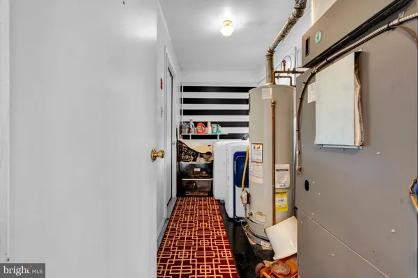 a view of walk in closet with clothes