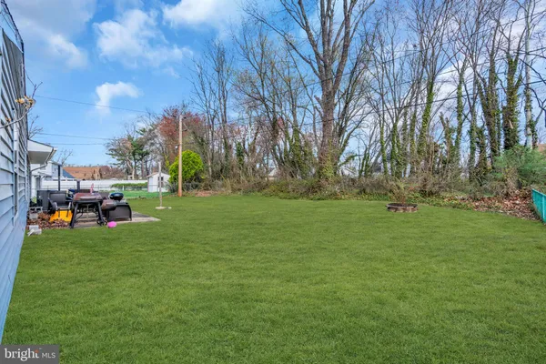 a view of yard with swimming pool and green space