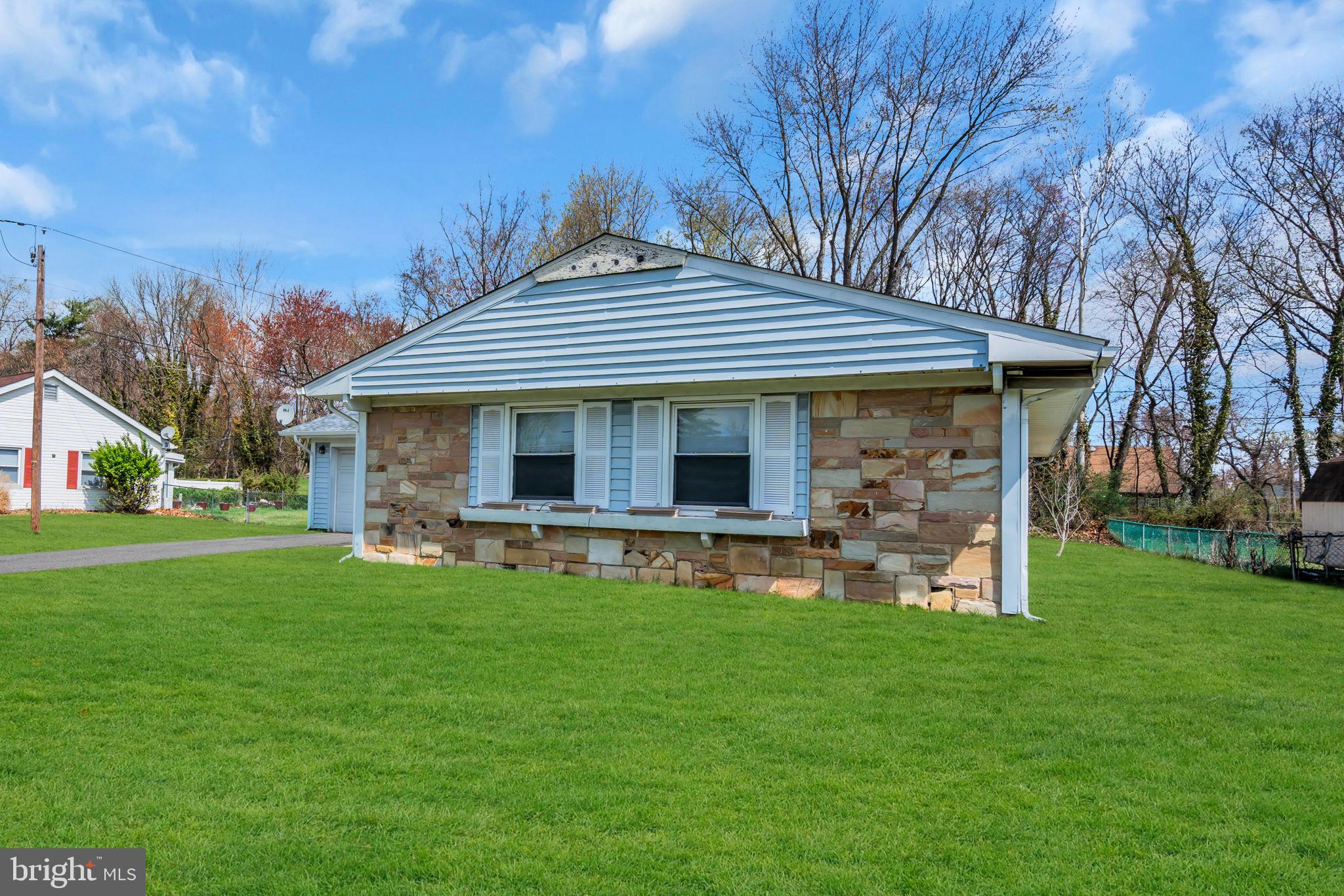 27 Genesee Lane Willingboro, NJ 08046 - Photo 2 of 25 a front view of a house with a garden and trees