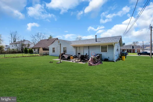 a view of a house with backyard porch and sitting area