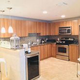 a kitchen with sink a microwave and cabinets