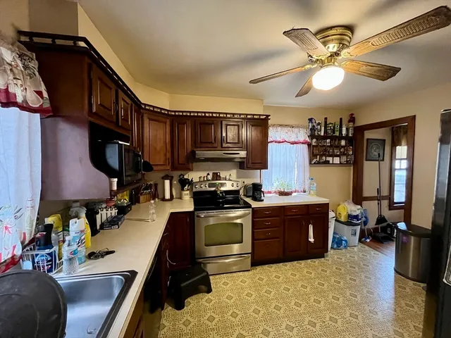 a kitchen with wooden cabinets and a stove top oven