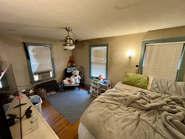 a bedroom with two beds and a chandelier