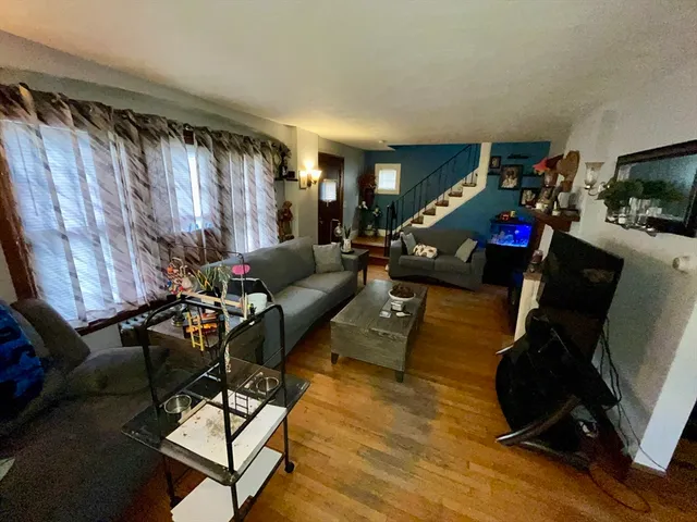 a living room with furniture gym equipment and a window