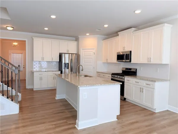 a bathroom with a granite countertop toilet a sink and bathtub