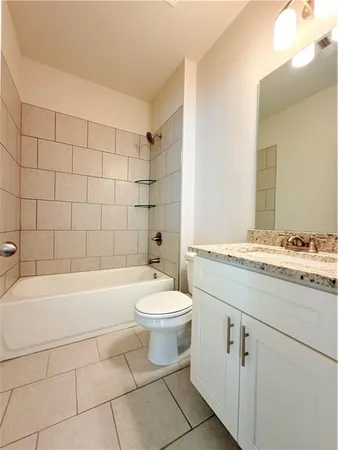 a large bathroom with a sink a mirror and a bathtub