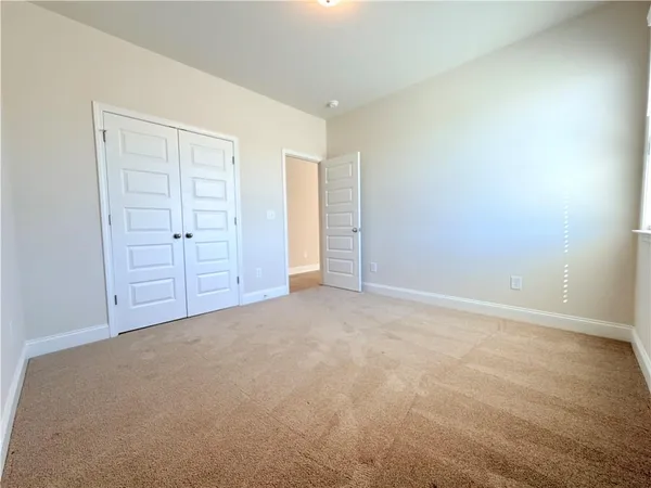 a large bathroom with a granite countertop sink a toilet a mirror and shower