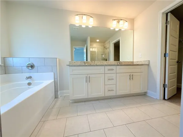 an empty room with closet and windows