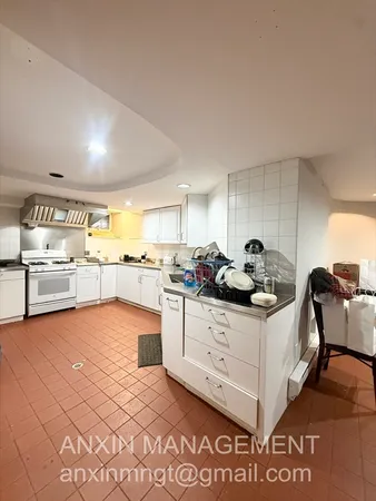 a kitchen with granite countertop a sink and cabinets