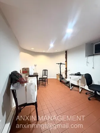 a view of a workspace with furniture and a table