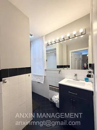 a bathroom with a sink a large mirror and a shower
