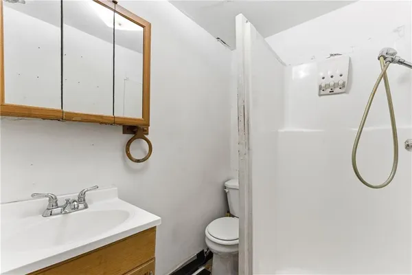 a bathroom with a sink a toilet and a mirror