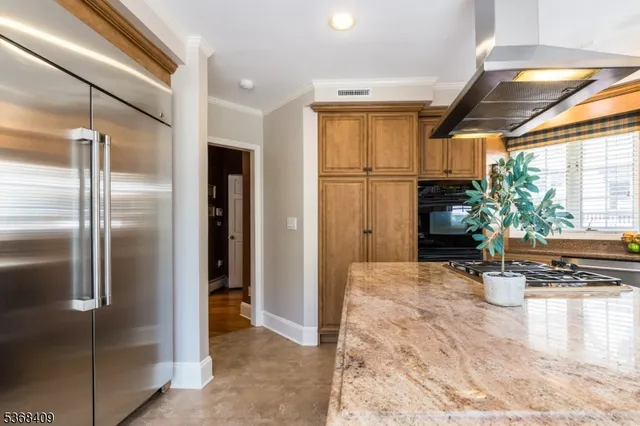a kitchen with refrigerator and window