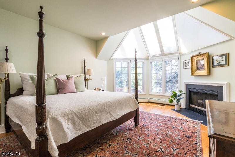 12 Kips Ridge, Unit 12 Montclair, NJ 07042 - Photo 17 of 37 a spacious bedroom with a bed and a fireplace