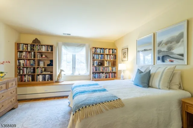 a bedroom with a bed and a book shelf