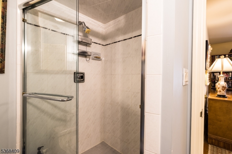 12 Kips Ridge, Unit 12 Montclair, NJ 07042 - Photo 23 of 37 a bathroom with a shower and a glass door