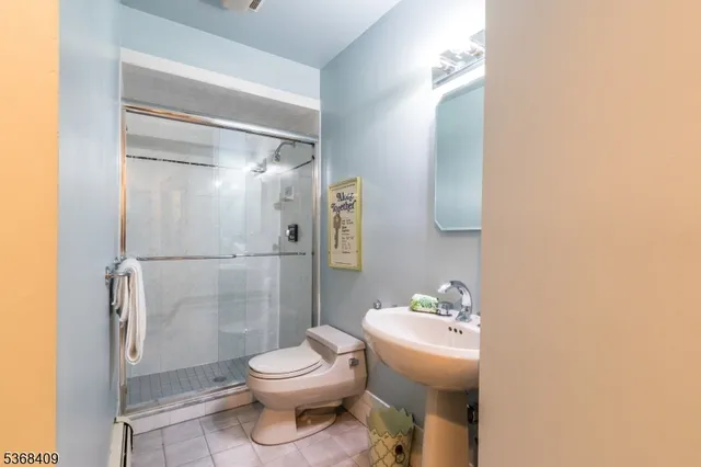 a white toilet sitting next to a bathroom sink
