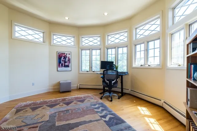 a view of a livingroom with workspace and a window
