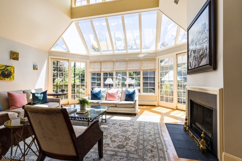 12 Kips Ridge, Unit 12 Montclair, NJ 07042 - Photo 3 of 37 a living room with furniture a fireplace and floor to ceiling windows