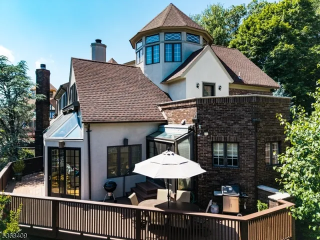 a front view of a house with yard and deck